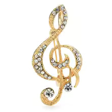 Broche en forma de clave de sol plateado y dorado